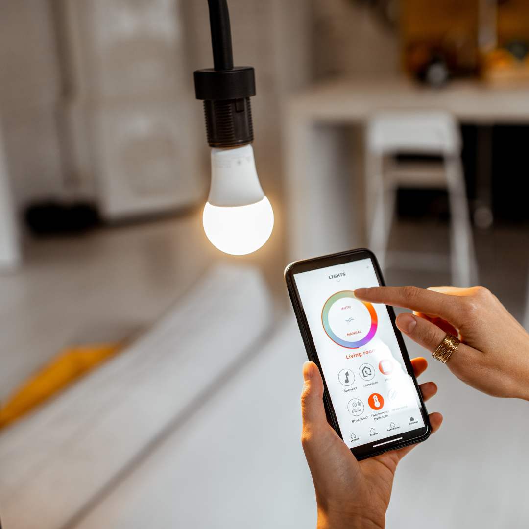 hands holding a phone to turn on a light