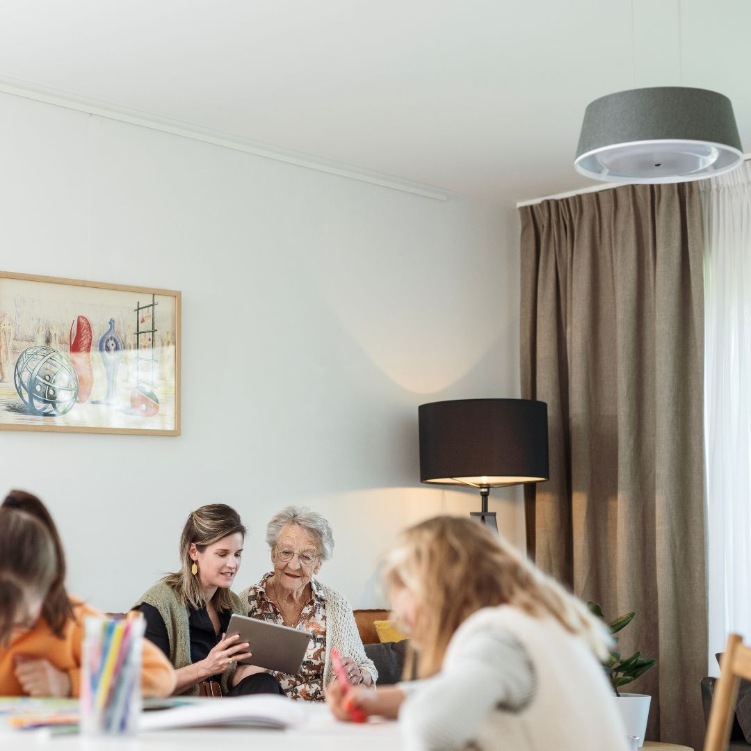 a grandmother with her granddaughters in the living room, where nobi is installed