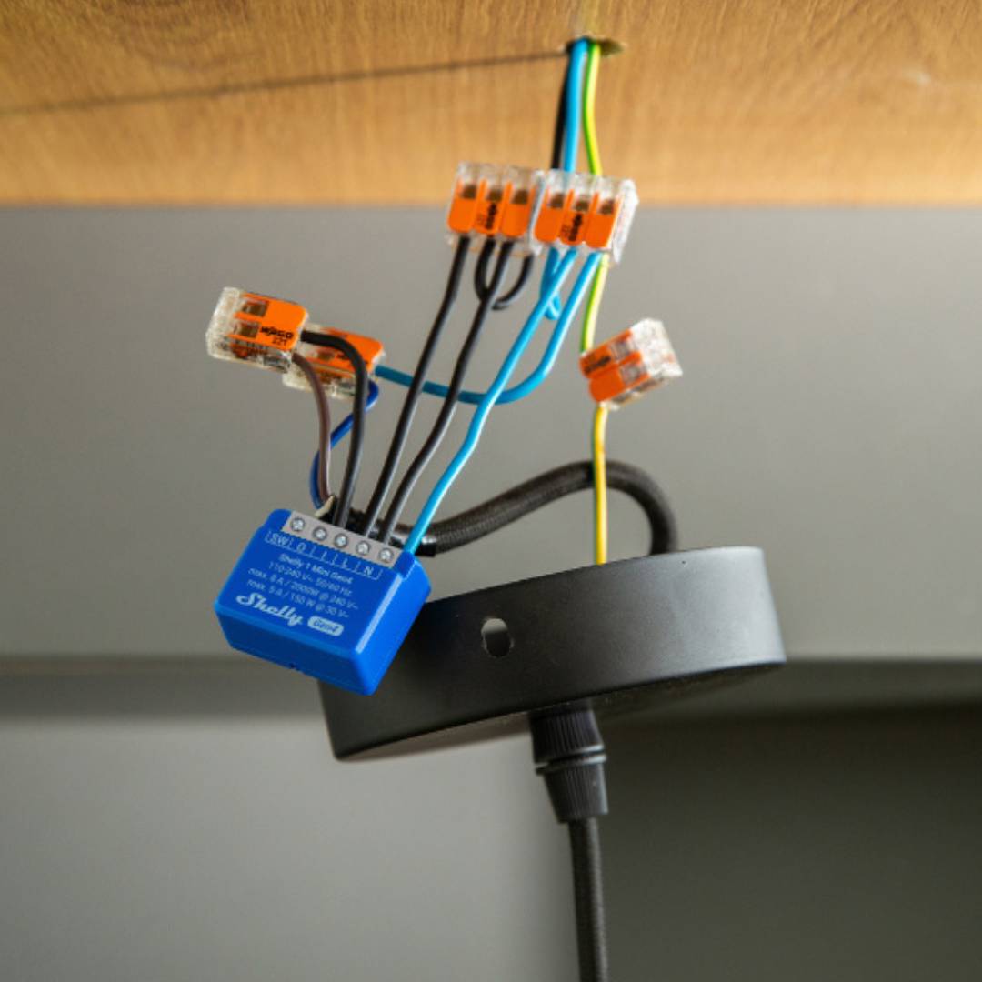 Electrical wiring with connectors and a blue electrical box on a gray background