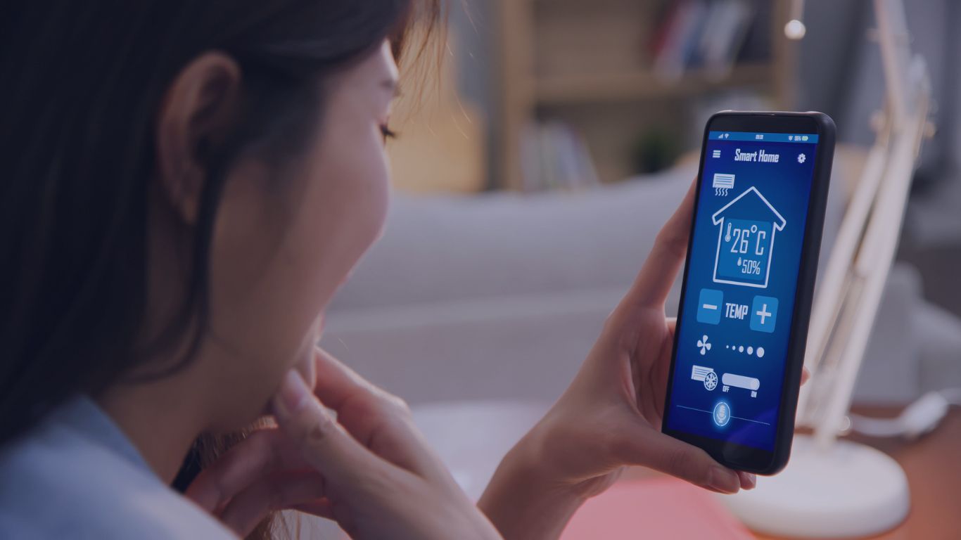 woman looking at the phone where it shows the temperature of the house