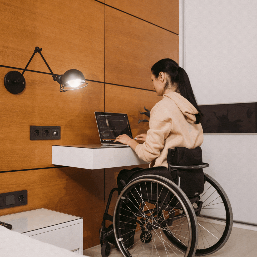 woman in a wheelchair working with a light next to her that turns on