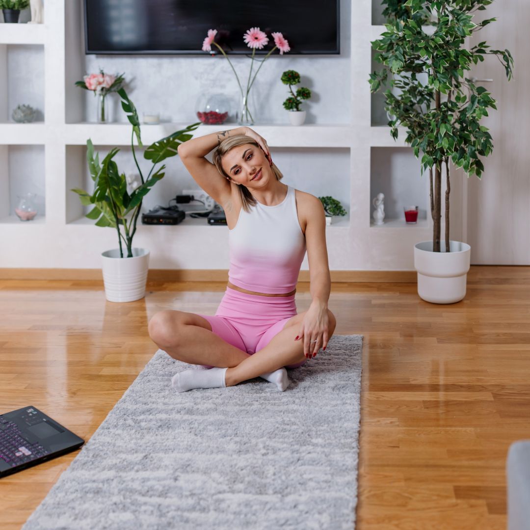 woman doing gymnastics on the floor of her house