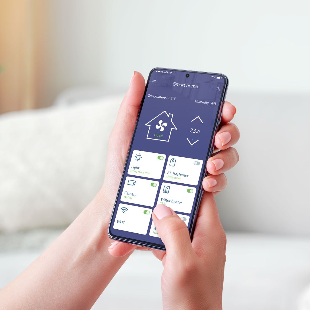 hands with a phone with an app controlling the temperature