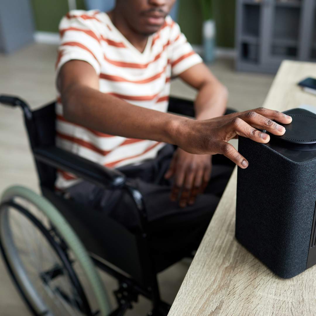 man in a wheelchair with a voice control device