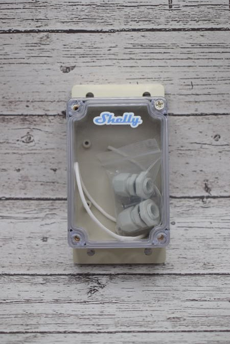 Shelly Outdoor Enclosure IP66 Rated with wood background